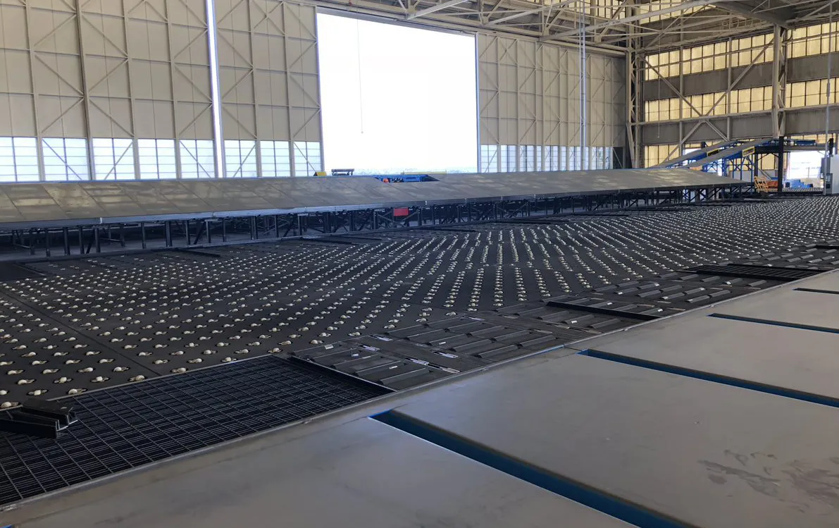 Cross-belt or tilt-tray sorter array viewed across a distribution facility