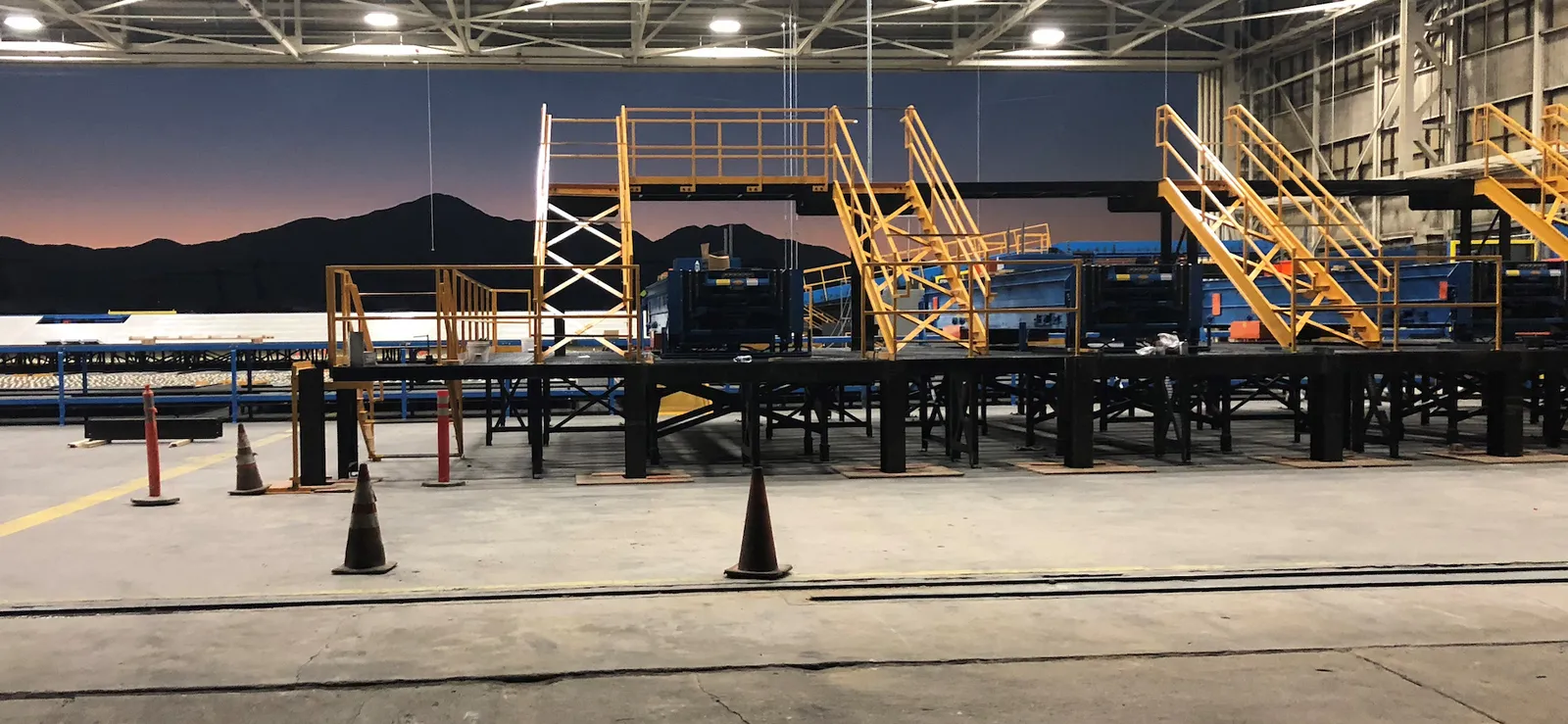 Sortation platform with access stairs at a parcel facility at dusk