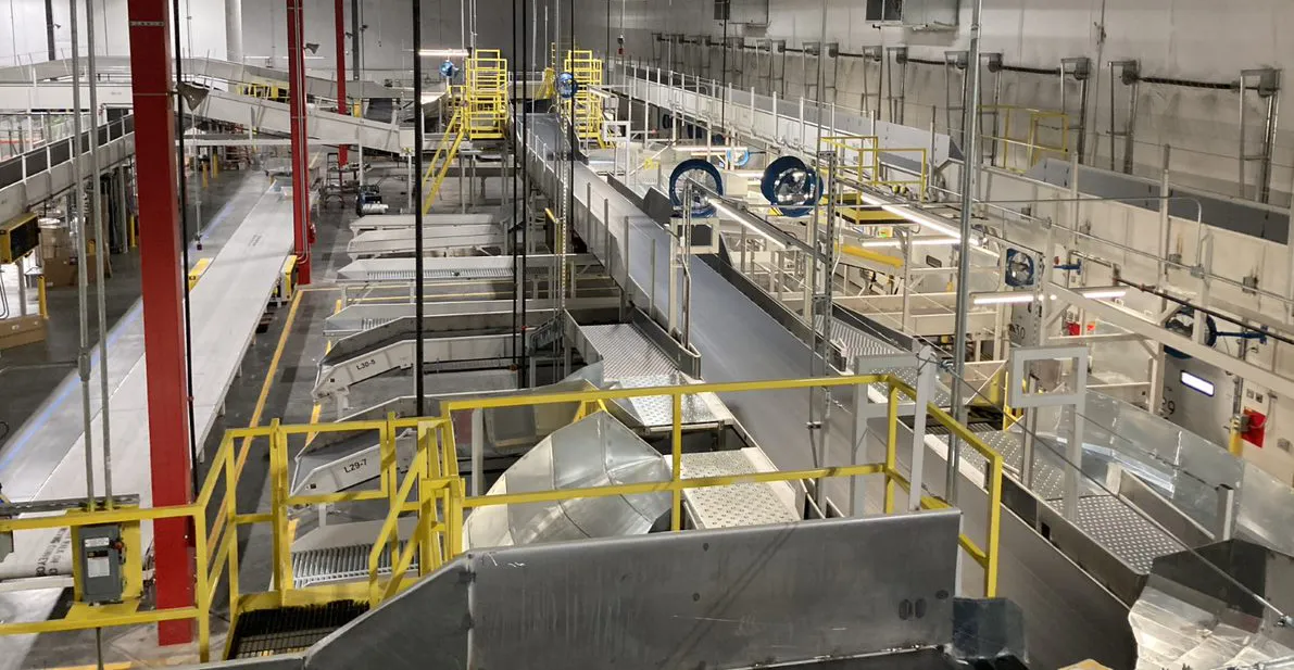 Elevated view of chute and conveyor sortation equipment in a parcel hub